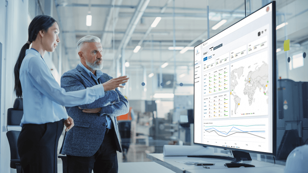 Image depicting a man and woman looking at an Arch System Dashboard.